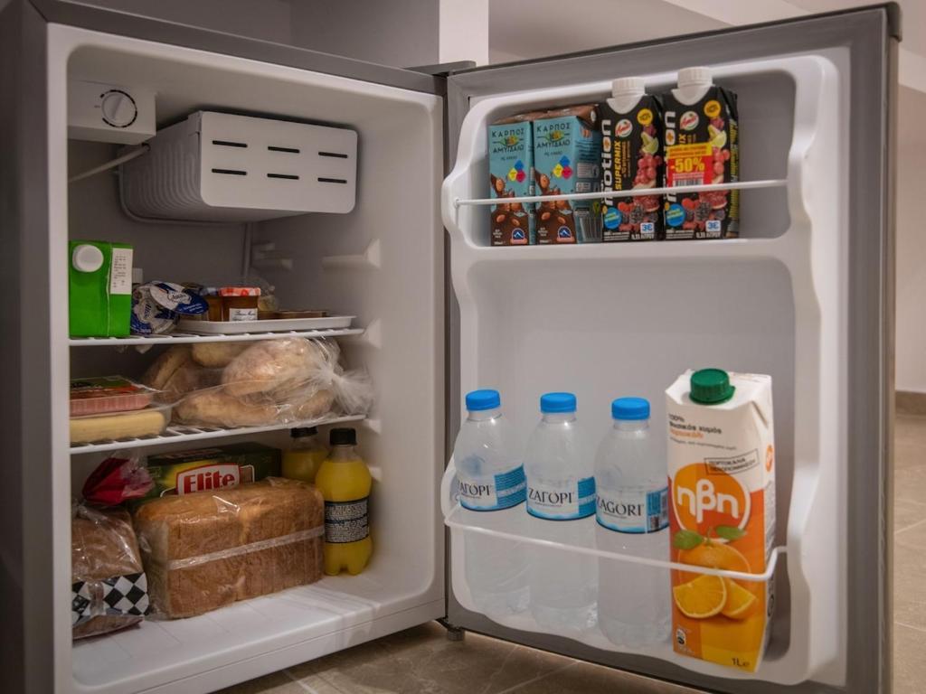 A mini refrigerator stocked with food and drinks.